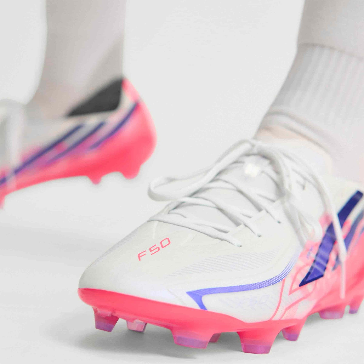 adidas F50 Hyperfast Pro FG soccer cleats in white, pink and navy with firm-ground outsole